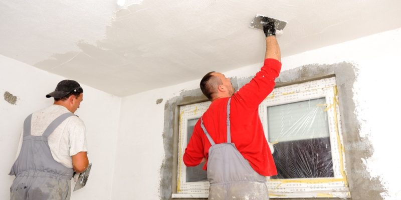 construction workers painting walls