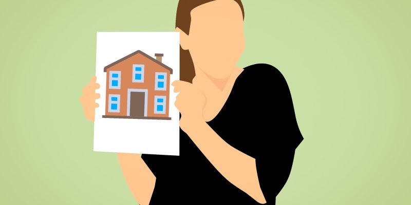 realtor holding image of house